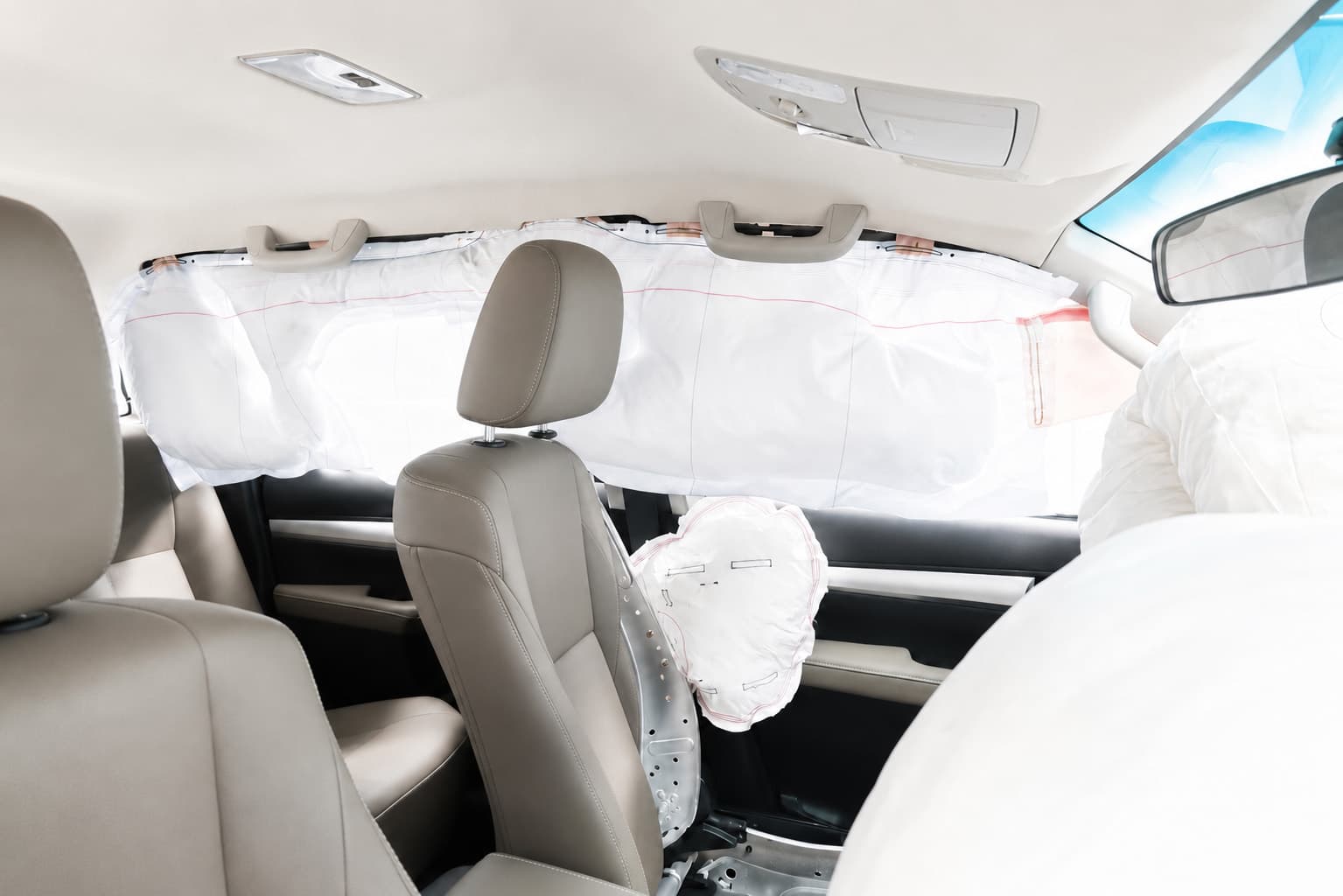 Vehicle cabin with deployed side and curtain airbags